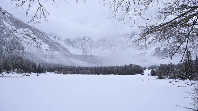 Winter in the Julian Alps. Snow-covered Fusine Lakes. Magic and winter atmospheres among the woods and rocky peaks of Friuli.