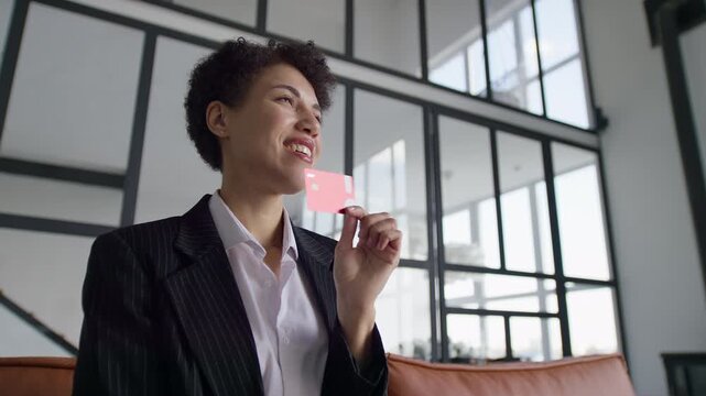Businesswoman celebrating with credit card