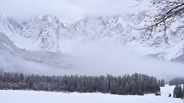 Winter in the Julian Alps. Snow-covered Fusine Lakes. Magic and winter atmospheres among the woods and rocky peaks of Friuli.