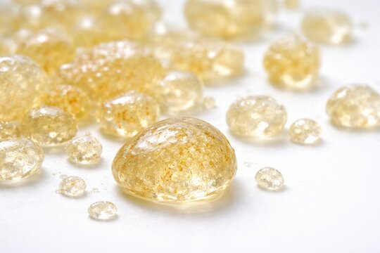 Macro shot of mastic resin drops isolated on white surface