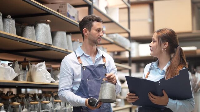 Warehouse workers man and woman checking inventory, Manager with clipboard and staff holding barcode scanner doing stocktaking, E-commerce fulfillment supply chain and logistics management business