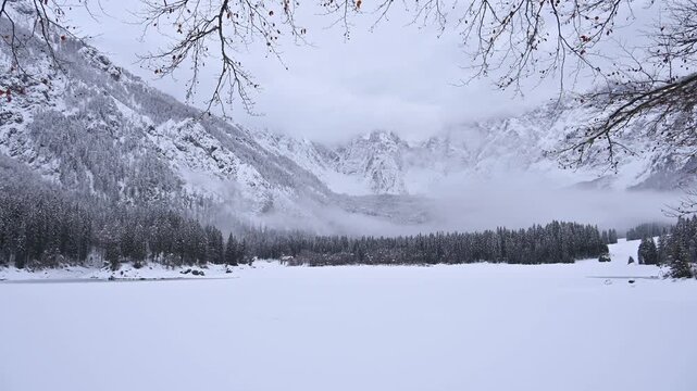 Winter in the Julian Alps. Snow-covered Fusine Lakes. Magic and winter atmospheres among the woods and rocky peaks of Friuli.