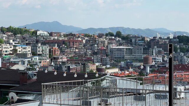Densely Packed Hillside Houses in Seoul with Mountain Ridge and Sky