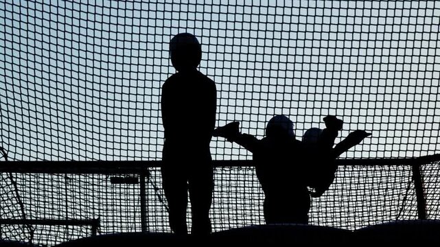 Instructors helping people experiencing flying in a vertical wind tunnel