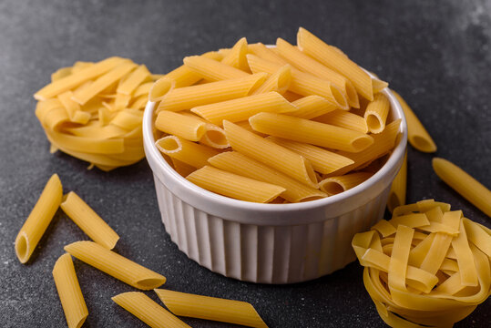 Italian uncooked dry penne regate pasta ready for cooking. Dry penne pasta