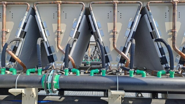 Close-up of Data Center Cooling System with Dry Cooler Coils, Copper Pipes and Industrial Piping Network