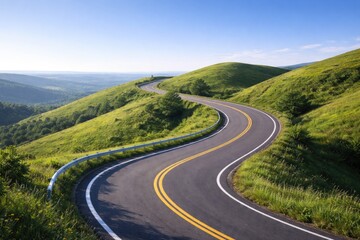 Fototapeta premium Curved roadbed on vibrant grassy hills with a serene blue sky background