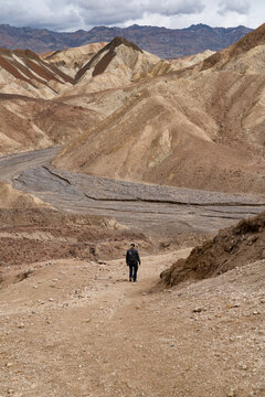 Woman hiking golden gulch desert trail death valley