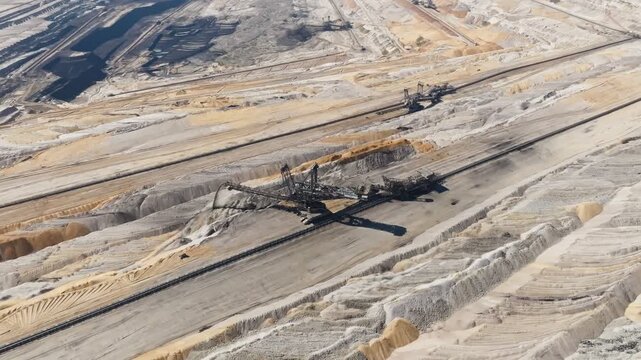 Ascending aerial of excavating machine on lignite coal mine in Germany