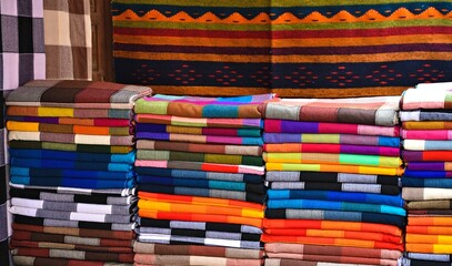 Fototapeta premium Authentic Mexican, handwoven, tribal colorful blankets on display in the Mercado de Artesanías, San Miguel de Allende, Guanajuato Mexico.