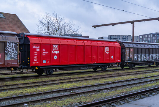 Red db cargo freight wagon in urban rail yard