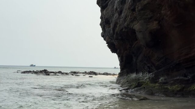 Volcanic Rock Cliff with Ocean Waves and Natural Erosion Patterns