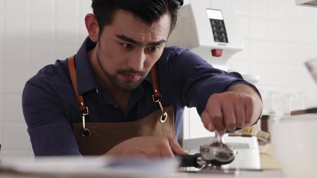 Professional barista prepare espresso brewing coffee use hand-held tamper, tamping freshly ground coffee beans powder in portafilter in cafe restaurant business shop, focusing on precision of process