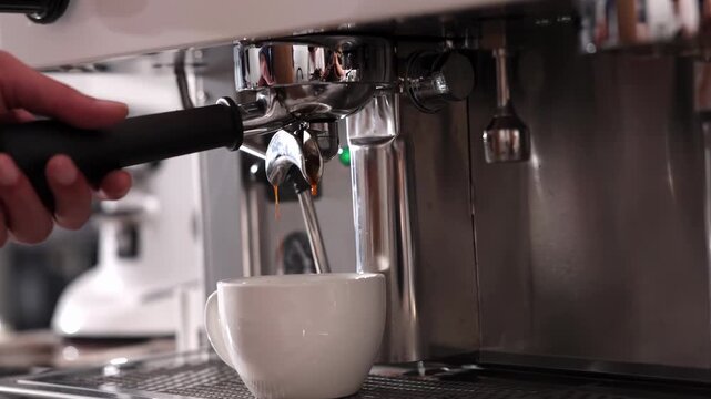 Automatic coffee machine pouring espresso into white cup during office break time, morning routine drink beverage, flowing fresh ground coffee, showcasing fresh crema and strong cafe brewing process