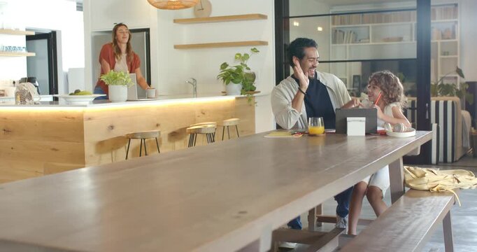 Diverse family at wooden table, man raising hand high-fiving child, helping on tablet, copy space