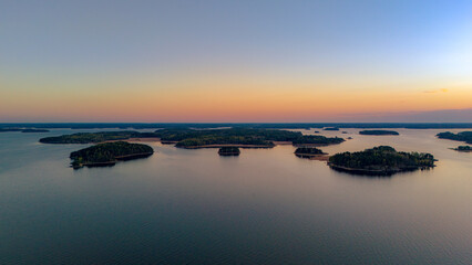 Top-down aerial view of small boats at a wooden pier on the rocky coast of Turku Archipelago © Light&Lens