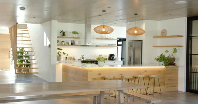 On start, camera is panning left revealing wood kitchen island and bench, showcasing layout