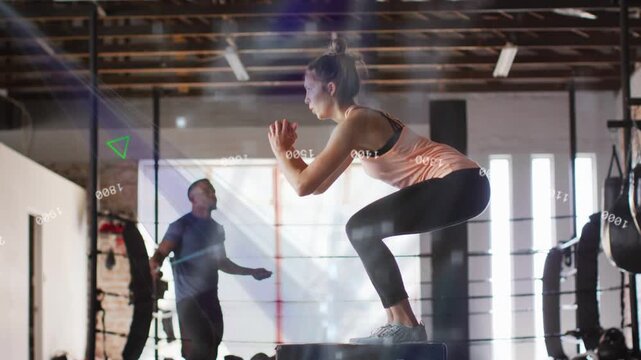 Woman bending knees jumping on plyo box landing man skipping HUD showing green training numbers