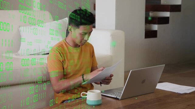 Man on floor scanning docs penciling bringing page to PC entering IT-data green overlay moving left