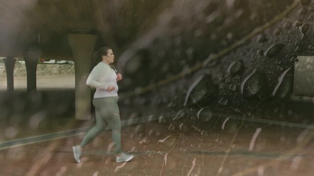 Runner jogging from left underpass entering frame and passing columns with rain overlay for health