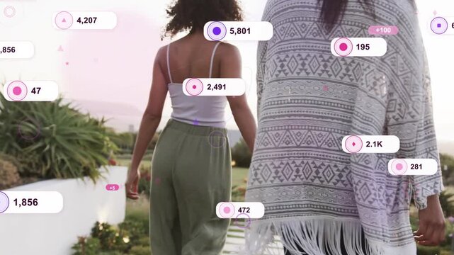 Two women walking holding hands on sunset lawn, metric badges multiplying around them for marketing