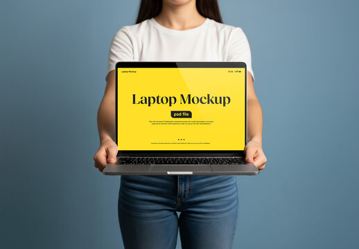 A woman holding a laptop in front of her &ndash; mockup