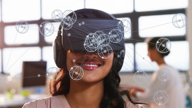 Woman wearing VR headset raising finger in bright office, making 3D nodes align for tech demo