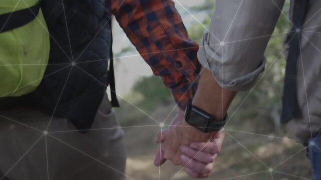 Senior man and adult woman holding hands, starting hike, tech overlay tracing watch and neon pack