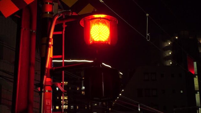 TOKYO, JAPAN - APRIL 2026 : Close up shot of crossing signal (warning light) at railway crossing. Japanese transportation, traffic and train concept video.