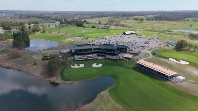 The TPC Toronto at Osprey Valley golf course and its expansive clubhouse are captured from above, highlighting the lush greens and surrounding landscape. Ideal for tourism or real estate promotions.