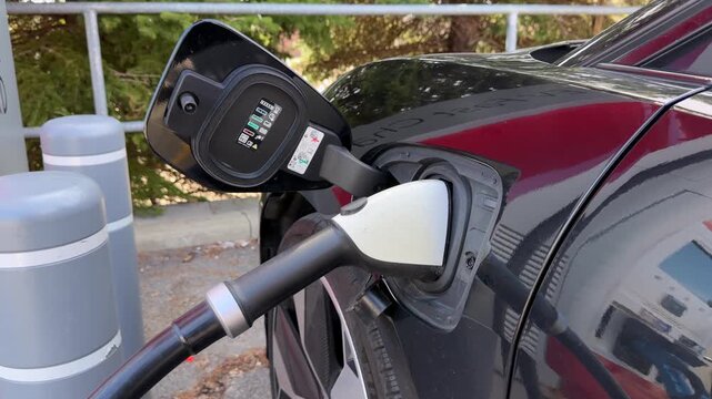 Electric Vehicle Fast Charger plugged into DCFC CCS plug during EV car road trip