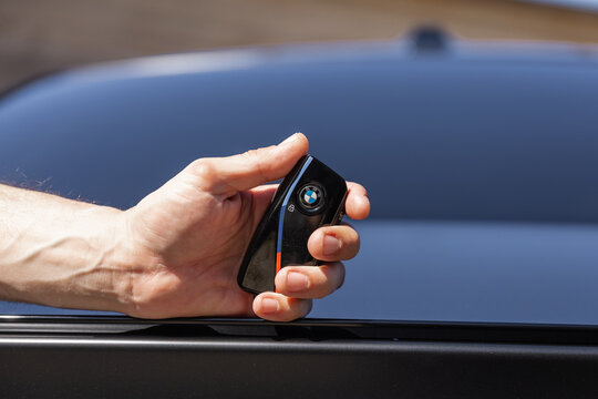 Slovenia, Ljubljana - 8 April 2026: A hand holds a BMW M5 car key with the logo visible, ready for use.