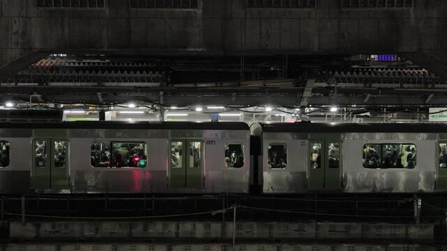 Night in Tokyo : As Urban Redevelopment Progresses and Station Buildings Are Exposed, Commuter Trains Standing at platform Begin to Move From Within | Shibuya Station, Tokyo, Japan