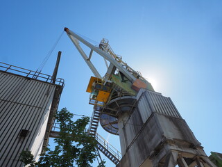 Fototapeta premium Industrial Crane at ENCI Site in Maastricht Against Clear Blue Sky