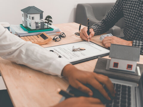 Signing a home purchase agreement with a reputable real estate agent and handling legal paperwork; concepts related to buying, selling, renting, investing, and the housing market.