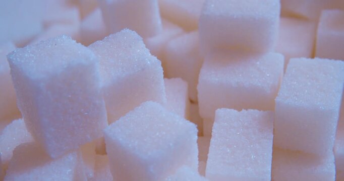 A macro shot of a pile of sugar cubes.Food background. The soft natural light. Closeup shot.