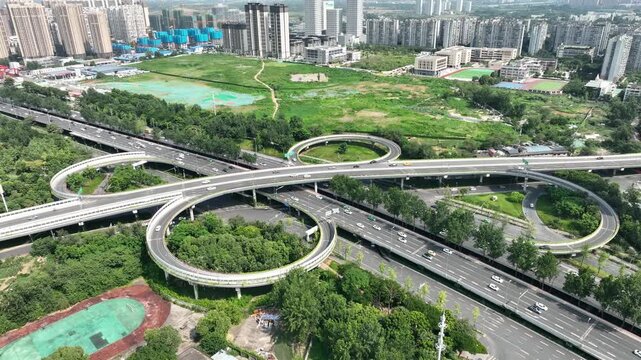 Aerial Urban Highway Interchange with Circular Ramps and City Buildings
