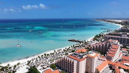 Fototapeta premium Palm Beach In Noord Oranjestad Aruba. Stunning Tropical Coastline Beach Scene Viewed From Above. Paradise Skyline Grateful Vibrant. Paradise Sea. Noord Oranjestad.