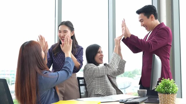 Asian entrepreneur group collaborates in office, fostering teamwork and cooperation to achieve their startup objectives. Their positive partnership drives success, creating a happy and successful job