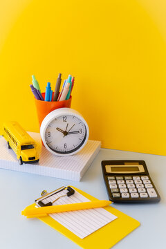 Study reset routine with clock calculator and school bus toy, time blocking academic productivity setup, dopamine desk stationery in bright yellow and blue, school admin core workspace still life