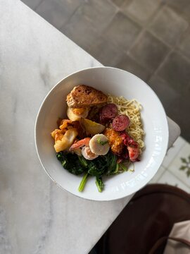 Yamie Singkawang, Authentic Indonesian Noodles with Savory Toppings. Indonesian Bakmi Singkawang with Meat, Fish Cakes, and Vegetables