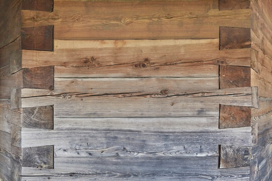Beautiful close-up of a wooden facade with an ornate corner joint.