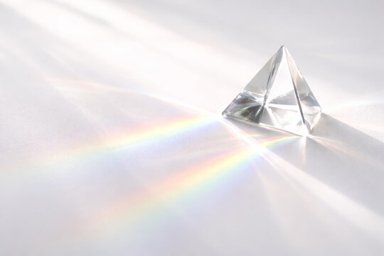 Crystal pyramid refracting light and creating rainbow patterns