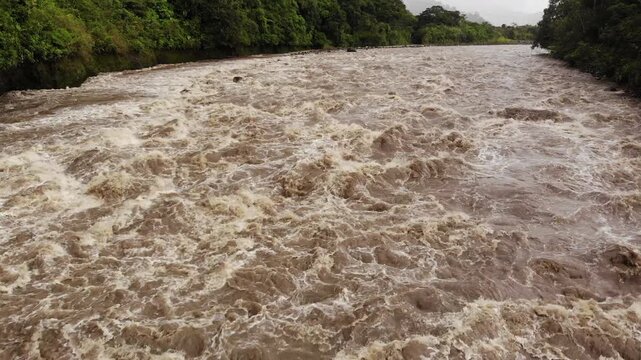 Aerial shot of Rio Quijos, Ecuador in flood, A tributary of the Amazon on the eastern slope of the Andes in Ecuador in flood after a tropical storm