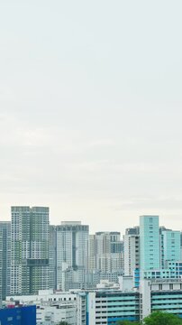 Panoramic zoom in view Skyline of residential high-rise buildings in Singapore. Blue and white HDB flats and modern apartments showcase urban density and planning in the heartlands