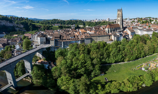 Aerial view of St-Nicolas Cathedral and the historic old town with the Zaehringen Bridge over the Sarine river in Fribourg, Fribourg, Switzerland.