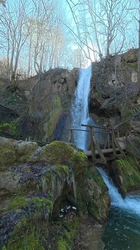 Mossy rocks frame a rushing waterfall. Mount Ozren, (Balkans, Serbia) Vertical