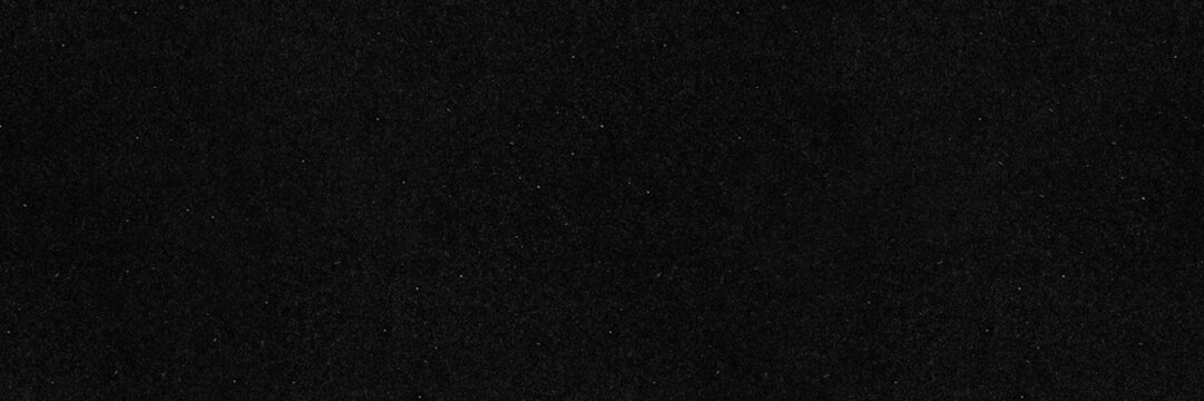 Dark film grain black paper seamless texture background. Old dust and scratch effect backdrop wallpaper.