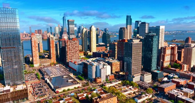 Sunny cityscape of modern Jersey City, New Jersey, USA. Distancing from the high-rises in the city downtown. Lots of cars go by the streets.