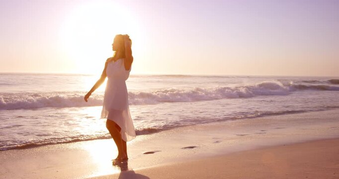 Travel, sunset or woman at beach with walking, carefree or peaceful perspective on ocean vacation. Stroll, seaside waves or tourist with freedom, calm mindset or summer evening on holiday break.